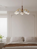Swedish modern brass and walnut chandelier in a bright room