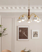 Brass and walnut chandelier glowing above a relaxed seating area