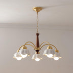 Midcentury brass chandelier with frosted ceramic shades over a table