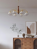 Brass chandelier with white ceramic shades in a furnished room