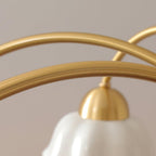 Brass chandelier with opaline ceramic shades above a long table