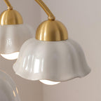 Walnut and brass chandelier lit softly in an elegant room