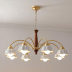 Brass chandelier with opaline shades lit above a dining setting