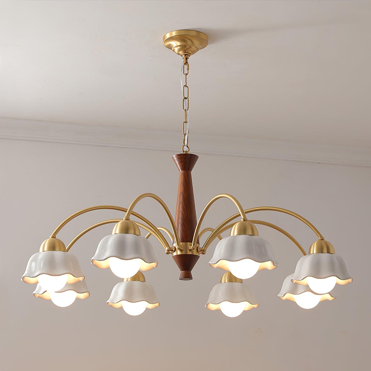 Brass chandelier with opaline shades lit above a dining setting