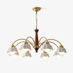 Swedish modern chandelier in brass and walnut against a pale ceiling