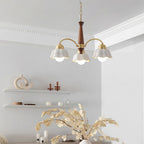 Brass arms and walnut centre of the chandelier seen up close