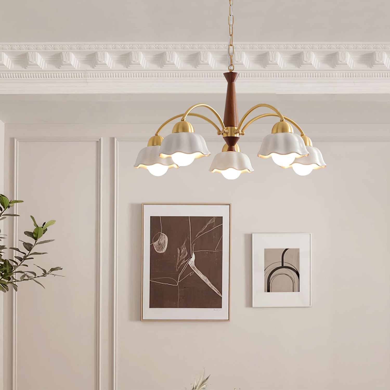 Walnut and brass chandelier with frosted shades over a sideboard