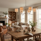 This satin nickel Clérachic chandelier, fitted with lampshades, hangs above a wood table in an open dining area.