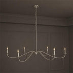 Studio view of this Clérachic chandelier in satin nickel, its curved arms shown without lampshades.