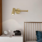 Gold swing arm wall sconce on a clean studio background