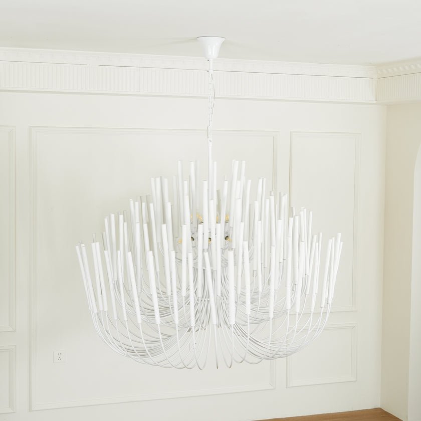 Wood rod chandelier viewed against a window with daylight