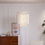 Natural wood chandelier lighting a dining table from above