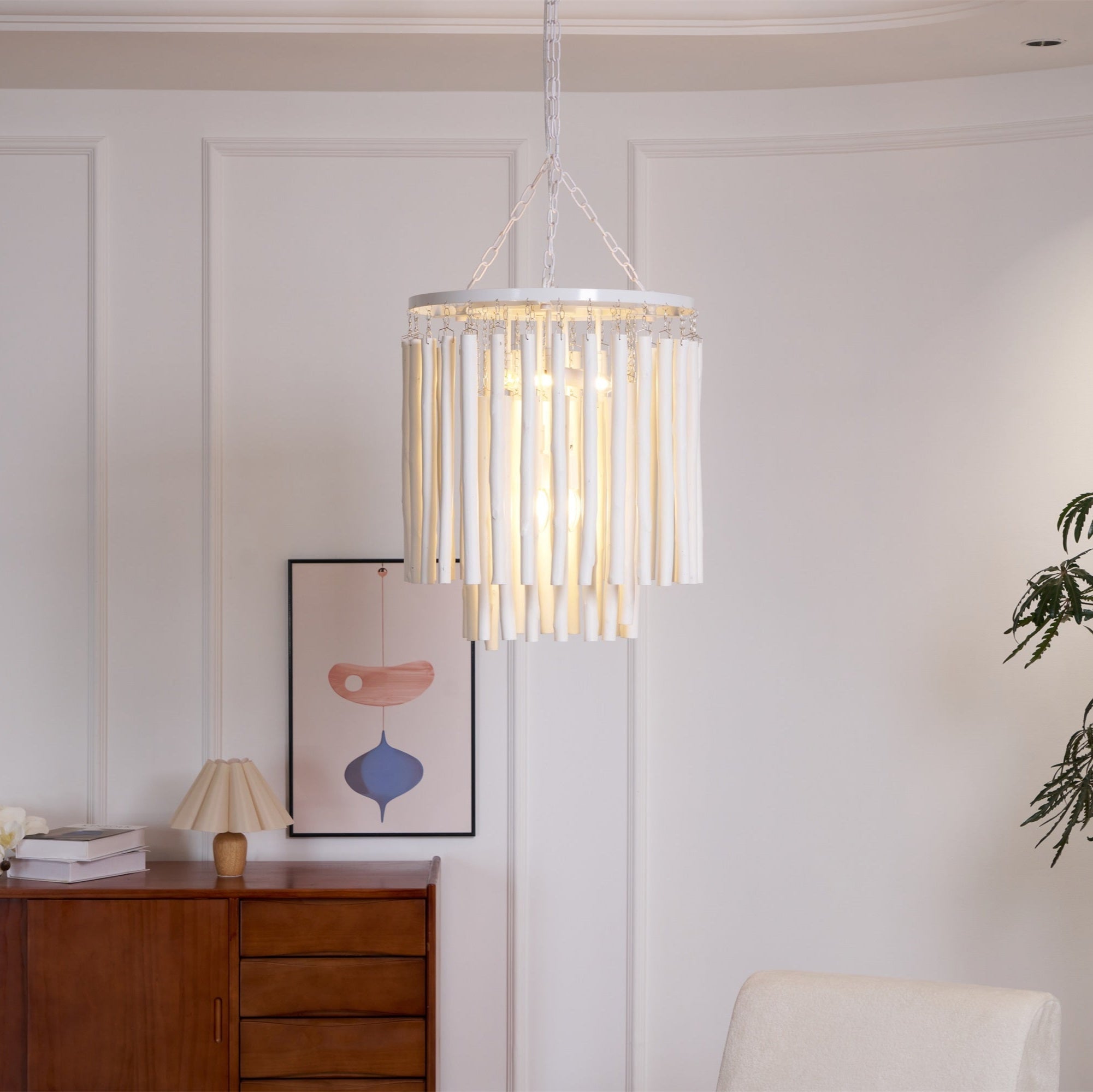 Natural wood chandelier lighting a dining table from above