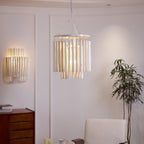 Wood rod chandelier shown over a bright open-plan room