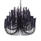 Layered natural wood chandelier against a pale ceiling