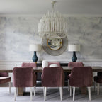 Wooden rod chandelier hanging above a modern dining table