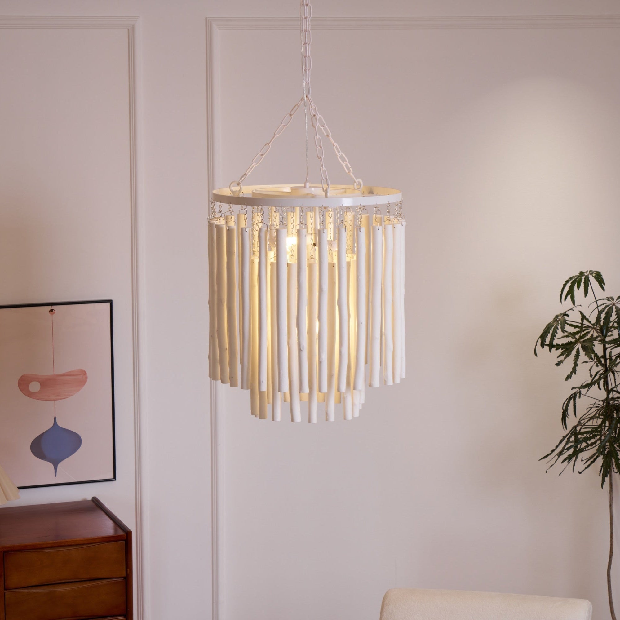 Wood rod chandelier lit with warm Edison-style bulbs