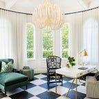 Swinton chandelier with layered natural wood rods on a white iron frame