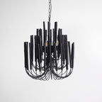 Swinton chandelier in black iron finish over a wooden dining table