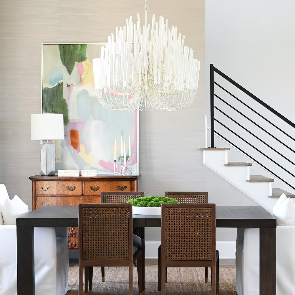 Swinton chandelier shown lit with warm white bulbs at night