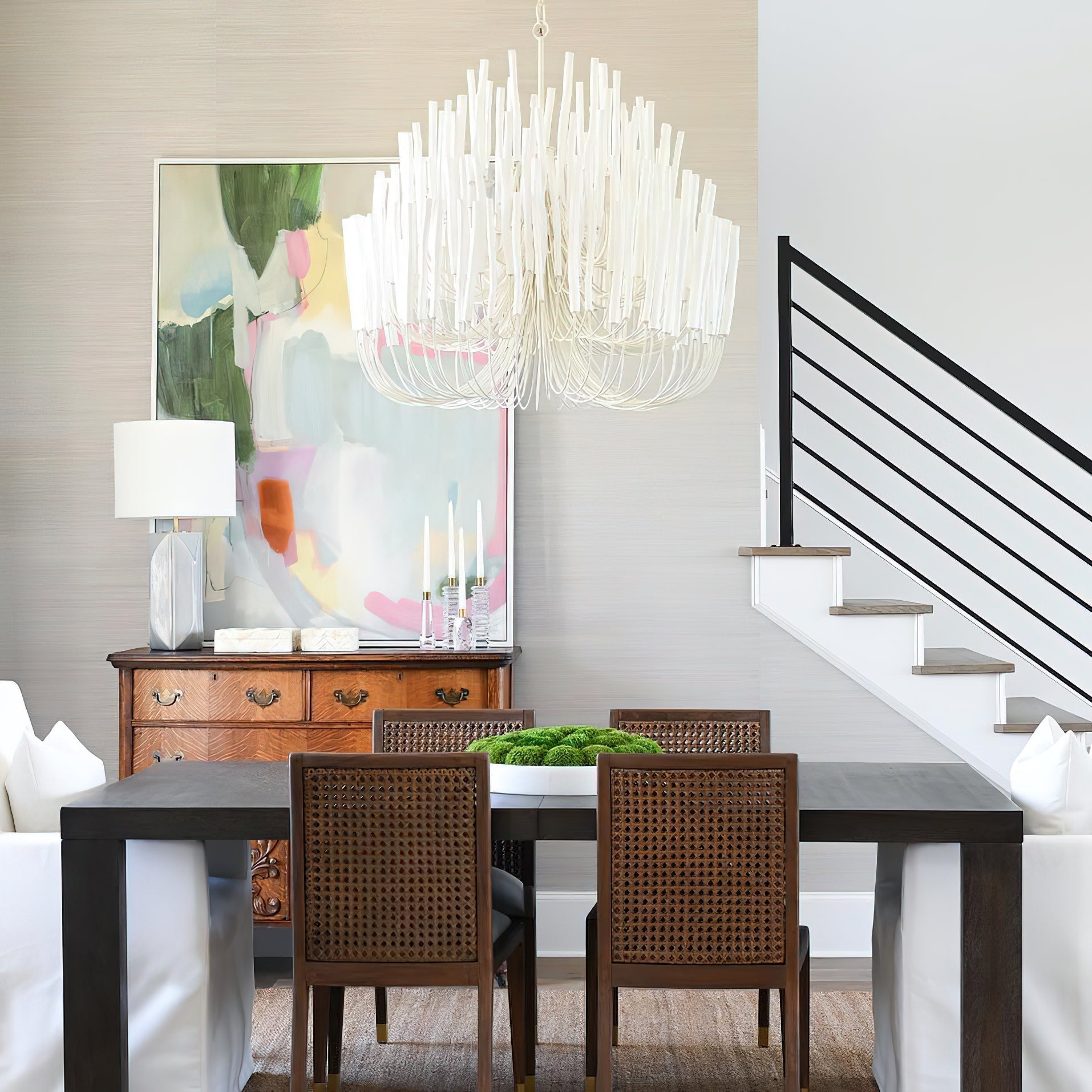 Swinton chandelier shown lit with warm white bulbs at night