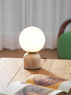 Sylas marble table lamp shown lit beside home decor pieces