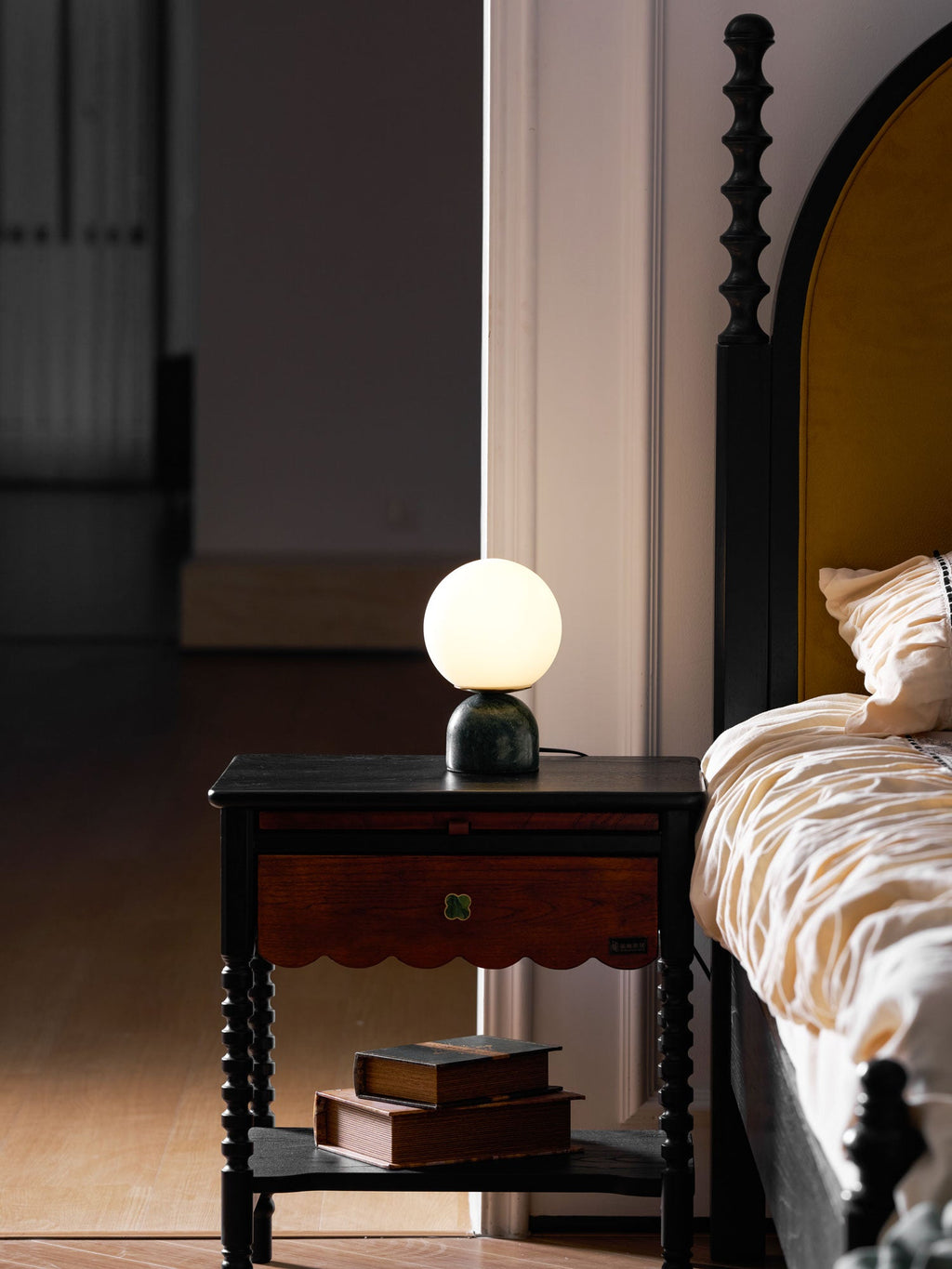 Sylas marble lamp with luminous white orb on a side table