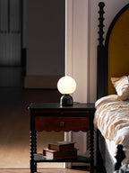 Sylas marble lamp with luminous white orb on a side table