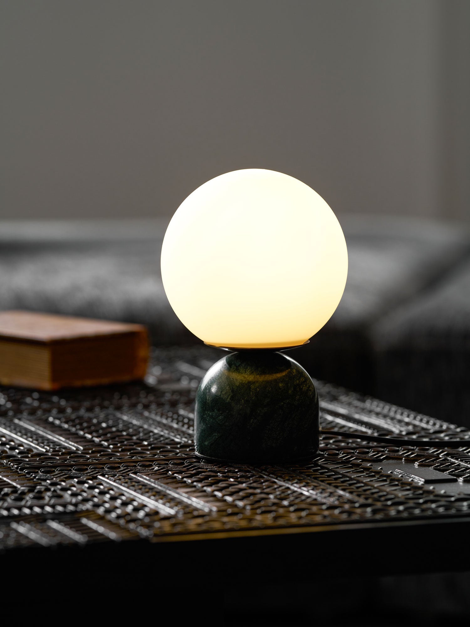 Marble table lamp with luminous orb in a warm living space