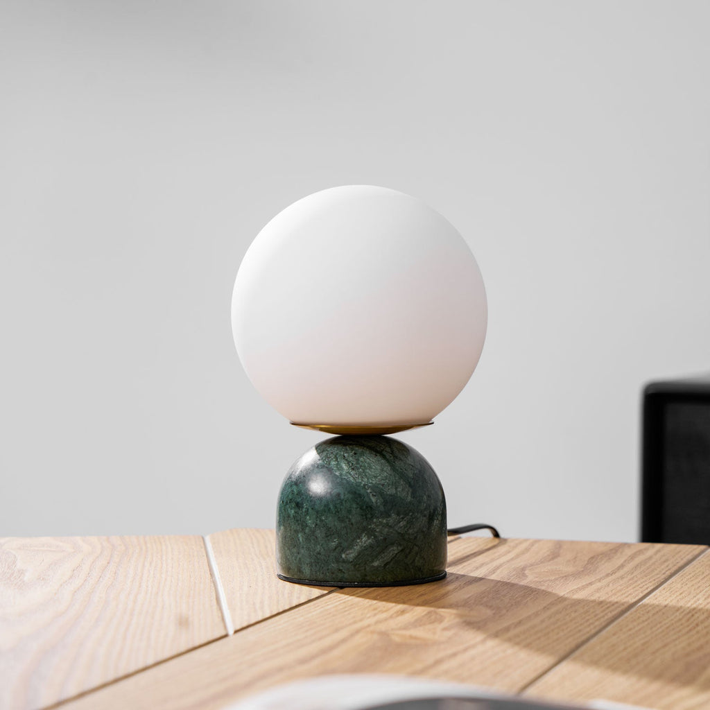 Sylas marble table lamp with white globe in a minimalist room