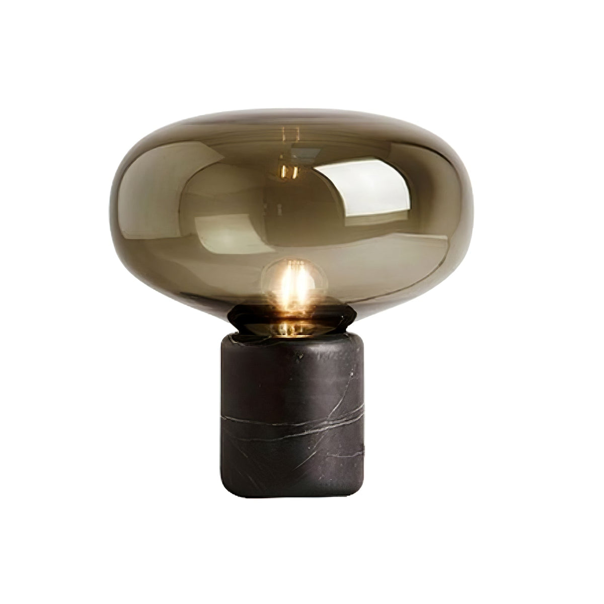 A closer studio crop of the amber-glass Clérachic table lamp on white, the dome and marble base filling the frame.