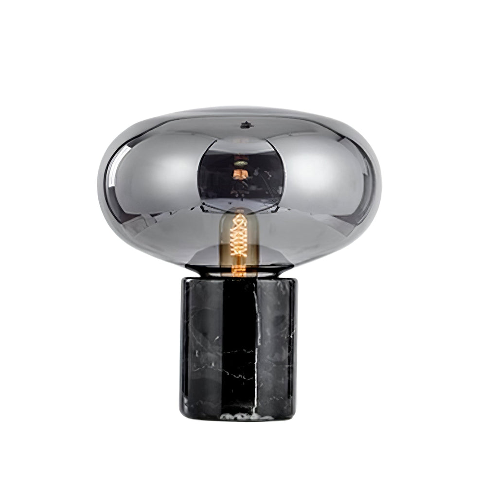 A studio shot of the Clérachic table lamp on white, showing the marble base's veining beneath the smoke-grey dome.