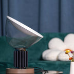 Table lamp side view showing aluminum reflector and clear glass