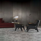 Aluminum table lamp lit beside seating in living space