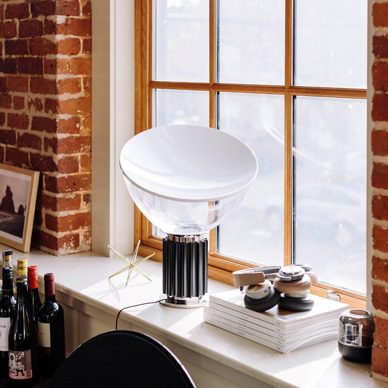 Aluminum reflector table lamp in a styled living room