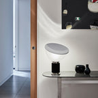 Aluminum reflector table lamp in warm-lit interior scene
