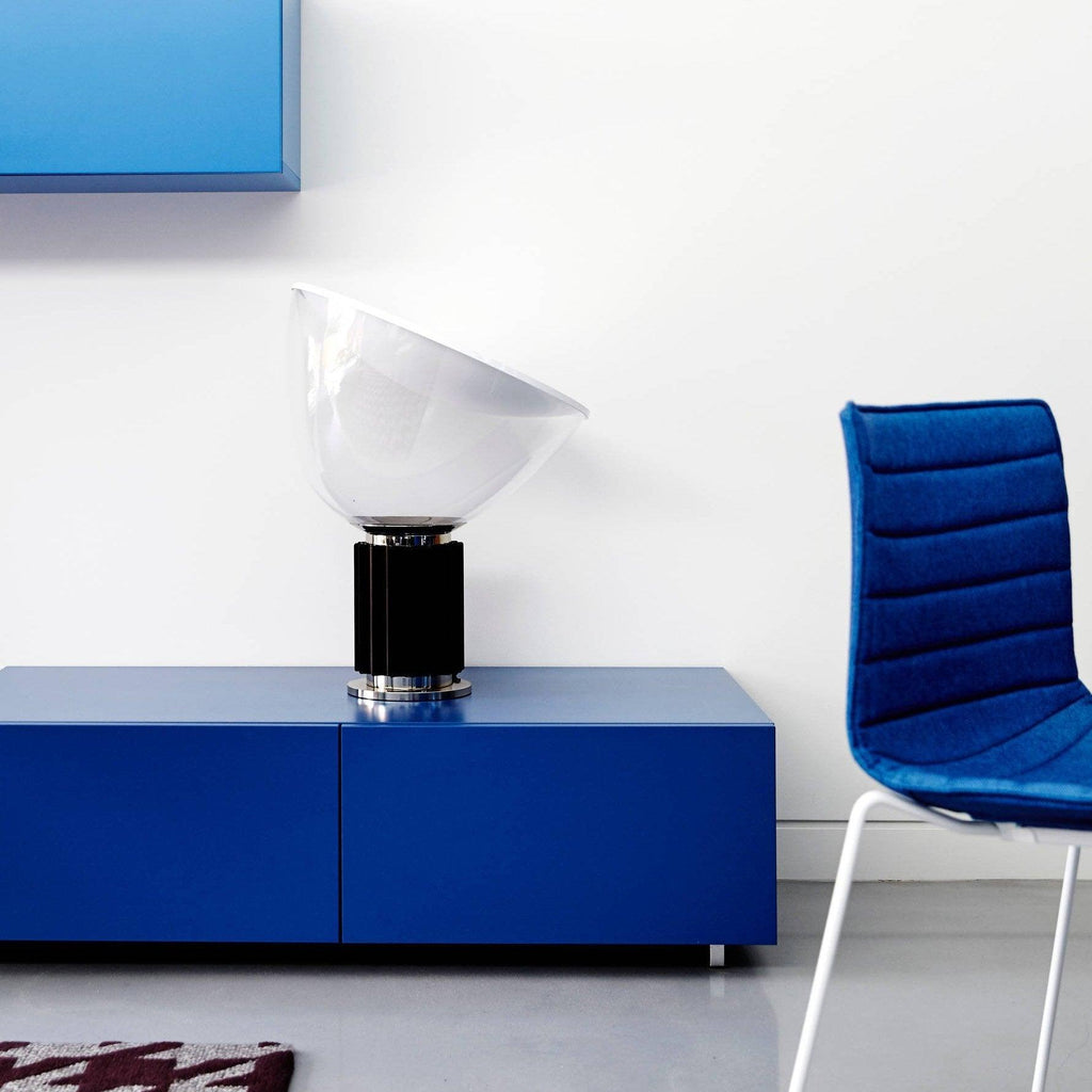 White bowl table lamp lit softly on a desk surface