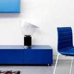 White bowl table lamp lit softly on a desk surface