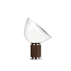 Table lamp glowing with warm light through clear glass diffuser