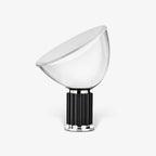White reflector table lamp glowing warmly in interior setting