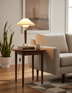 Beige fabric table lamp with walnut wood base shown upright