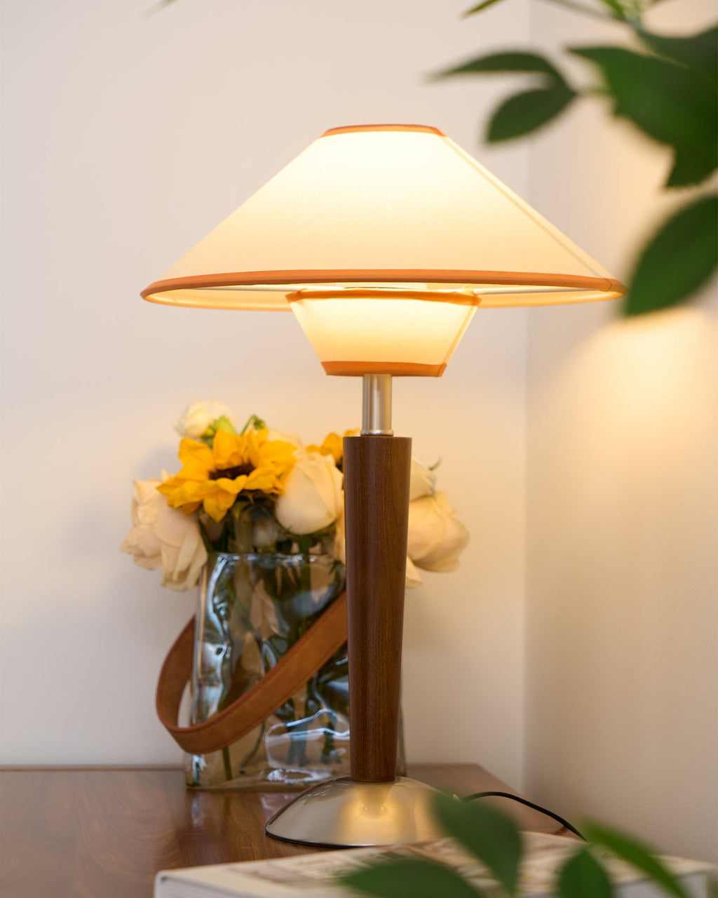 Walnut wood table lamp with soft fabric shade and warm glow