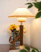 Walnut wood table lamp with soft fabric shade and warm glow