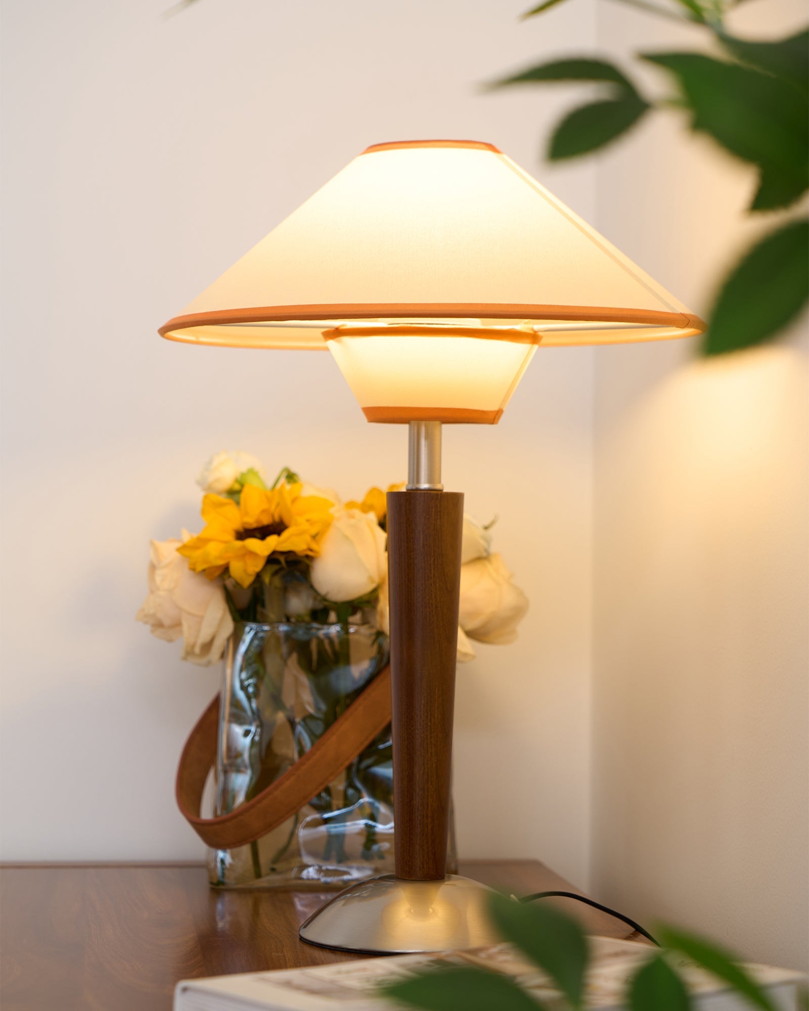Walnut wood table lamp with soft fabric shade and warm glow