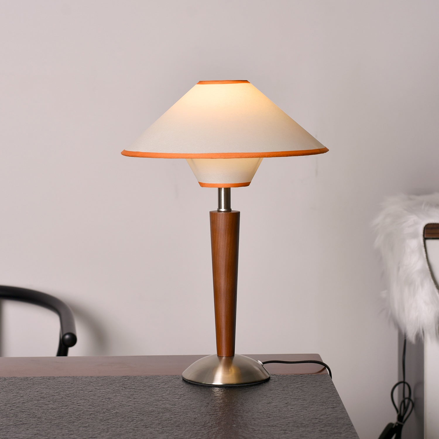 Fabric shade table lamp detail showing warm light and walnut base