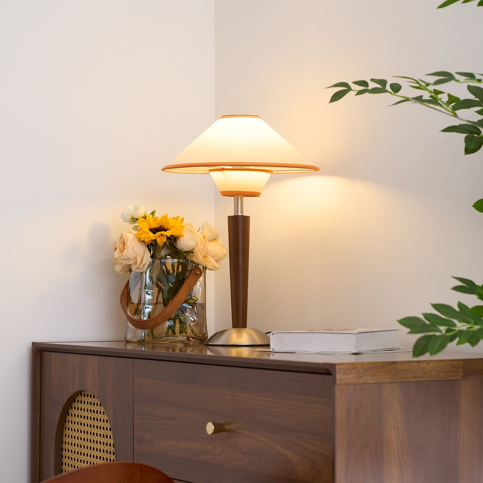 Table lamp with fabric shade casting soft warm bedside light