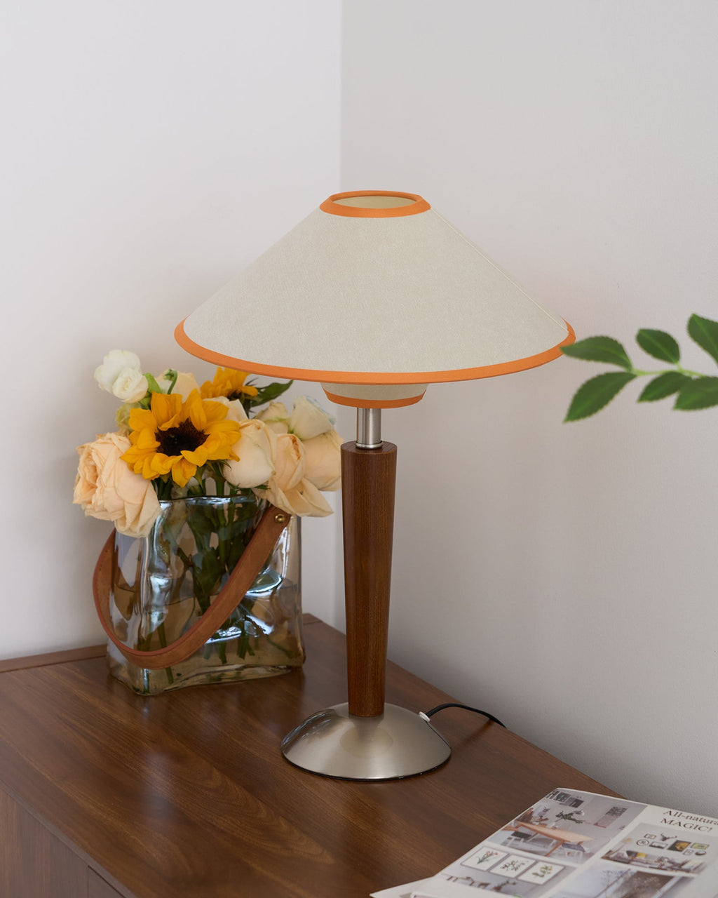 Green fabric table lamp with walnut base in a cozy room