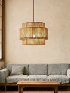 Over a grey sofa and wood coffee table, this Clérachic pendant adds warmth to a plaster-walled living room.