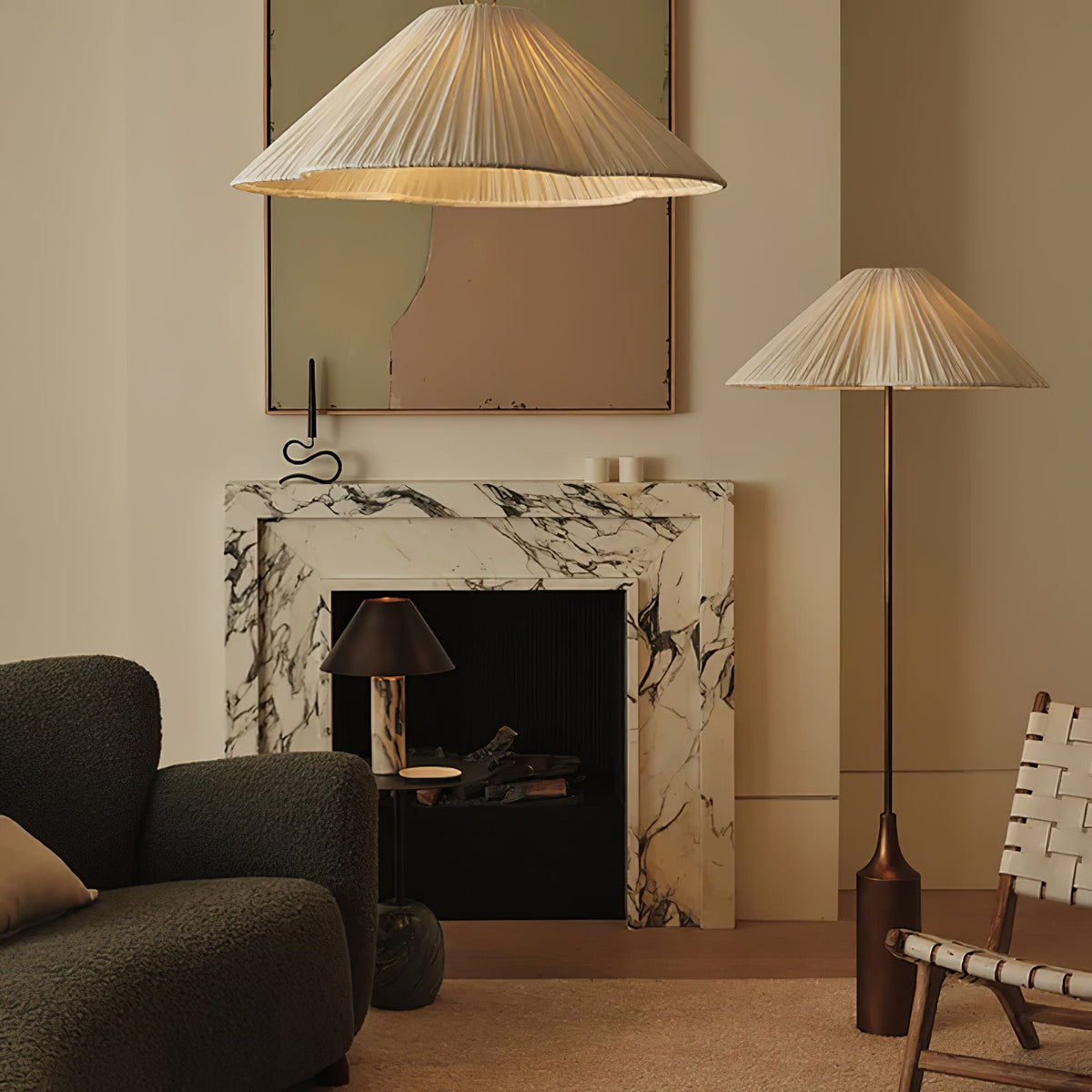 Clérachic pleated white shade pendant and matching floor lamp glow beside a marble fireplace and dark green sofa in a living room.