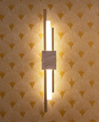 Marble wall lamp casting warm uplight on a hallway wall